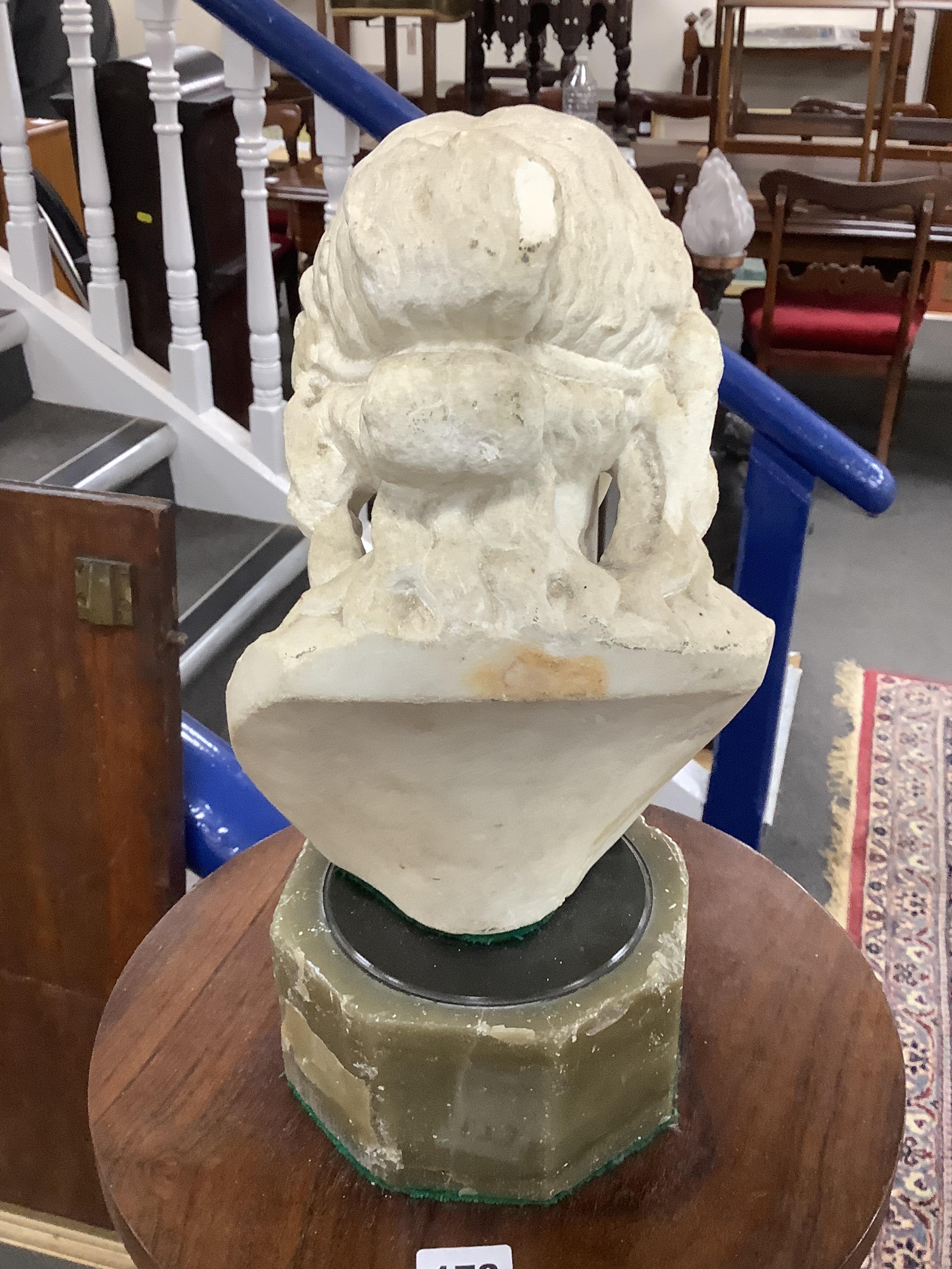 After the Antique, a carved marble bust of a young woman on octagonal onyx plinth and rosewood pedestal, combined height 142cm